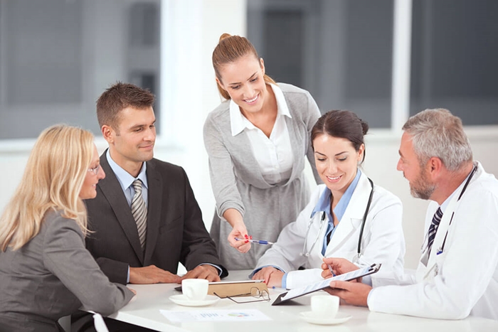 doctors meeting with businesspeople